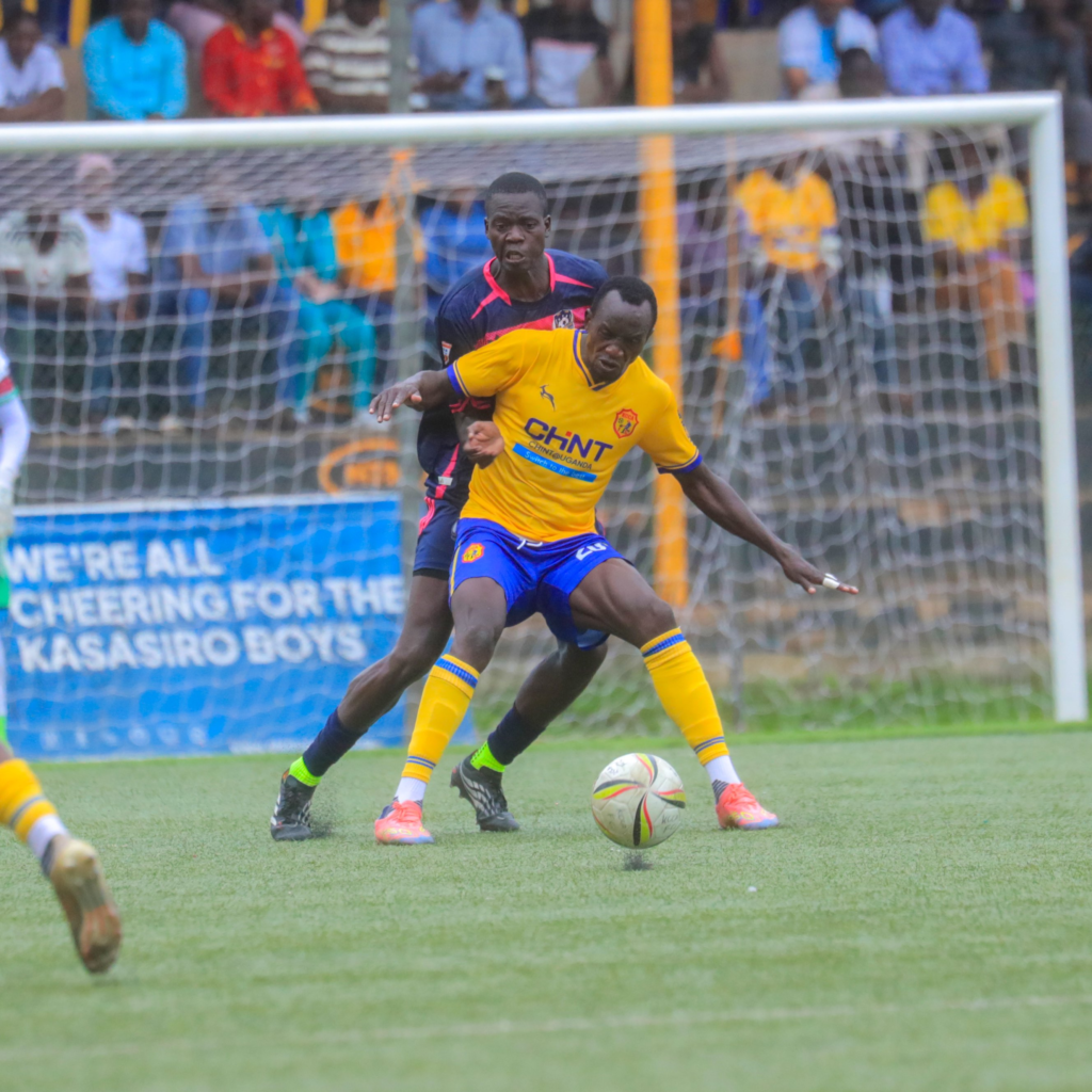 KCCA forward Emmanuel Anyama controls the ball under pressure from a Kataka defender during the Uganda Premier League match.