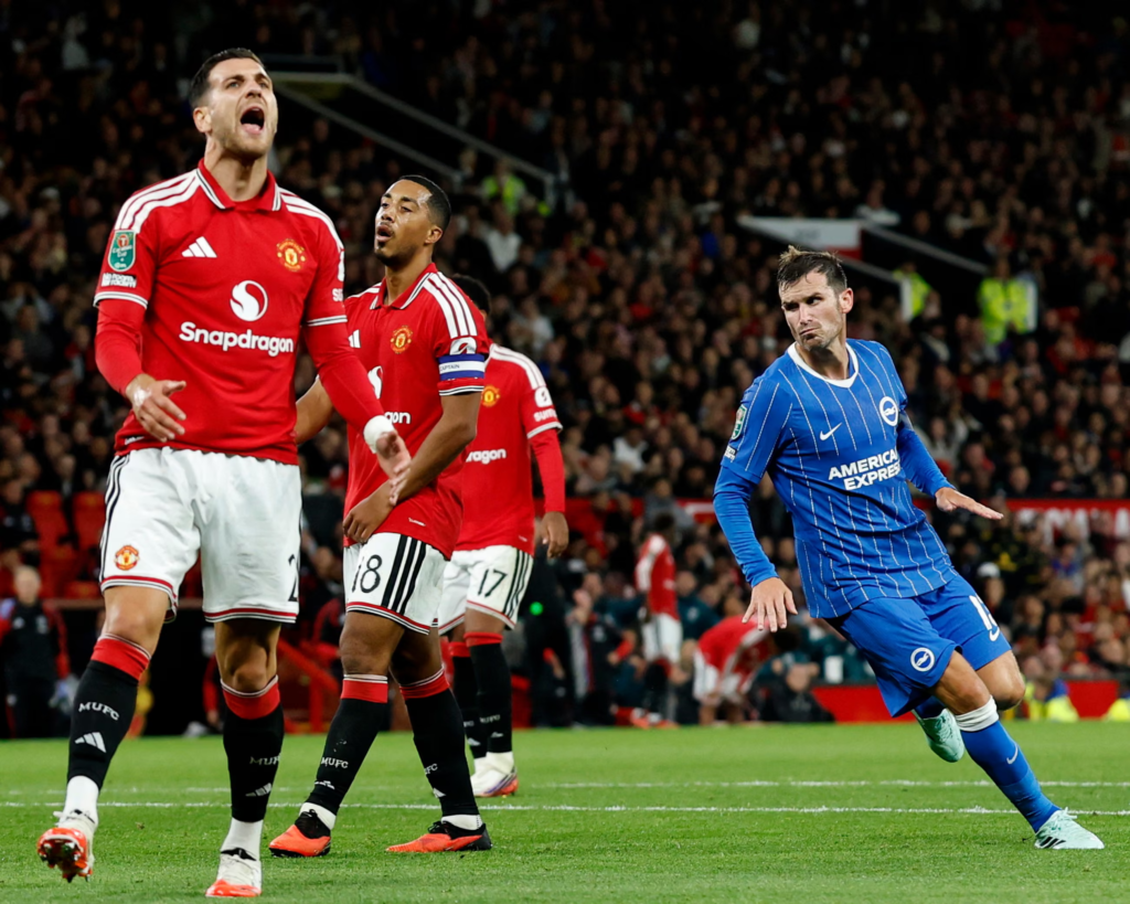 Manchester United players react with frustration after Pascal Gross scores Brighton's equalising goal.