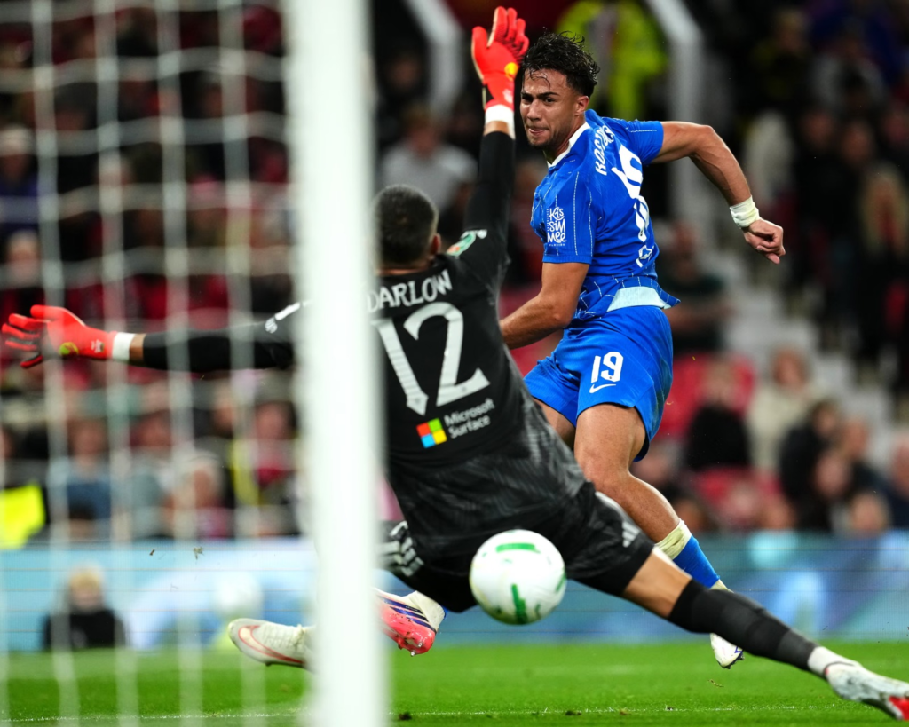 Brighton's Charalampos Kostoulas celebrates after scoring to kick off the team's comeback just before half-time.