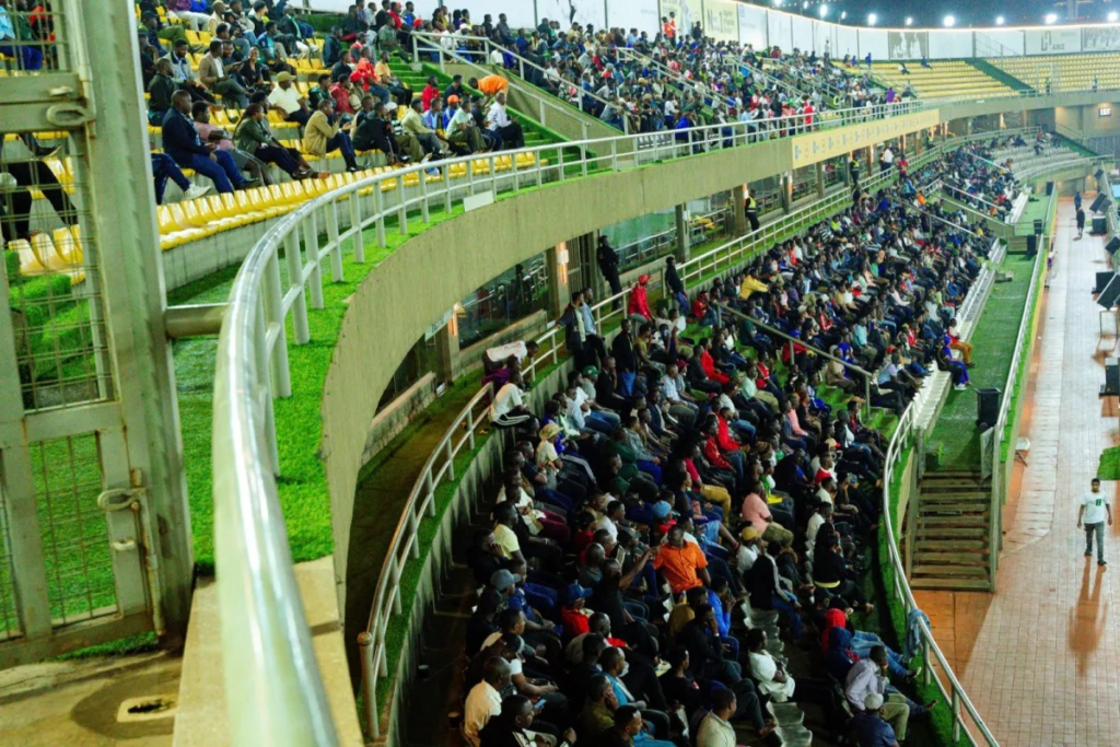 A large crowd of football supporters seated across the upper and lower stands at Hamz Stadium during the Express FC versus Kitara FC match.