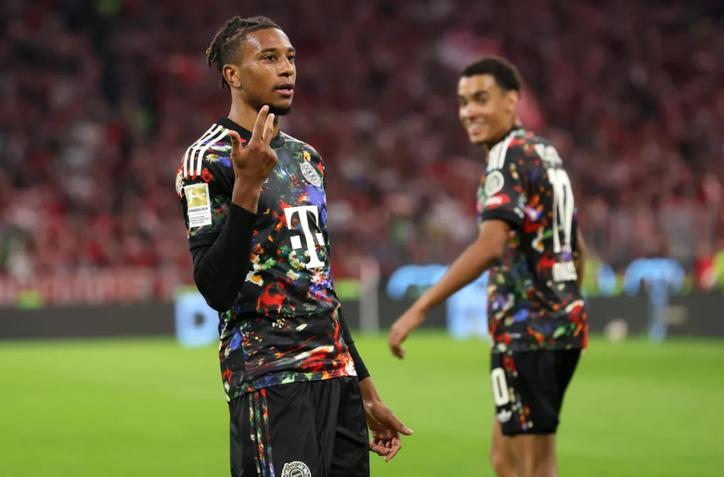Michael Olise of Bayern Munich celebrating after completing his hat-trick, scoring his team's seventh goal against Union Berlin.