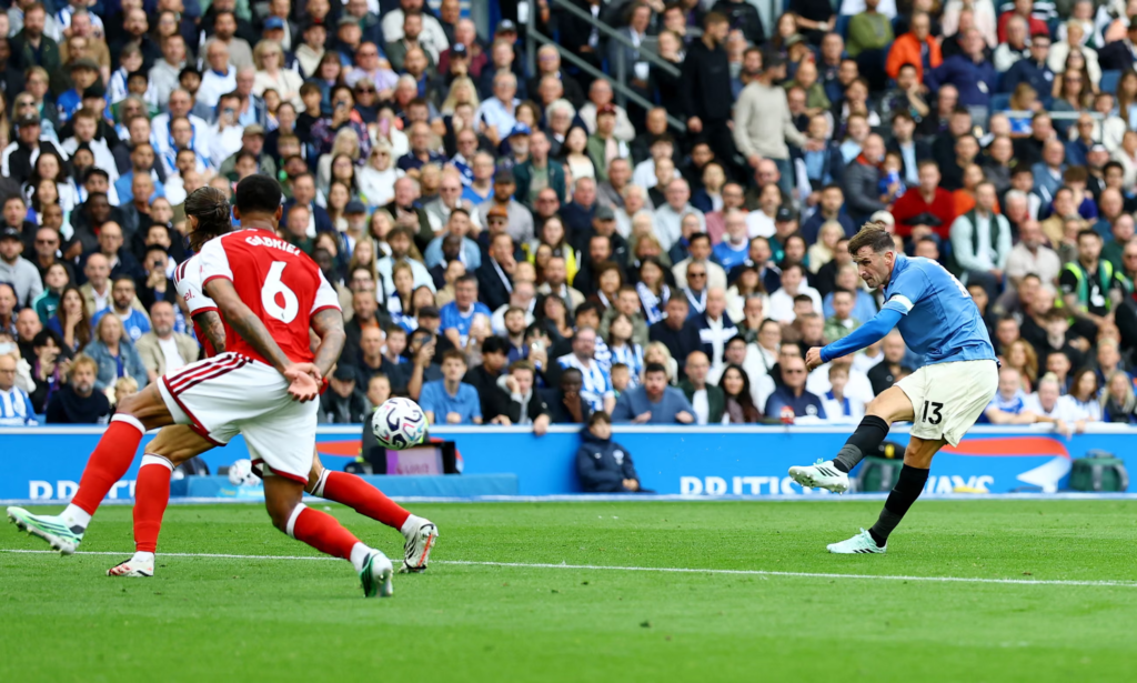 Pascal Groß striking the ball to score Brighton's opening goal against Arsenal.