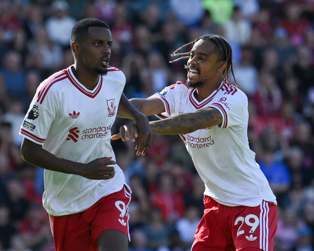 Liverpool player Alexander Isak being congratulated by teammate Bradley Barcola after scoring a goal.