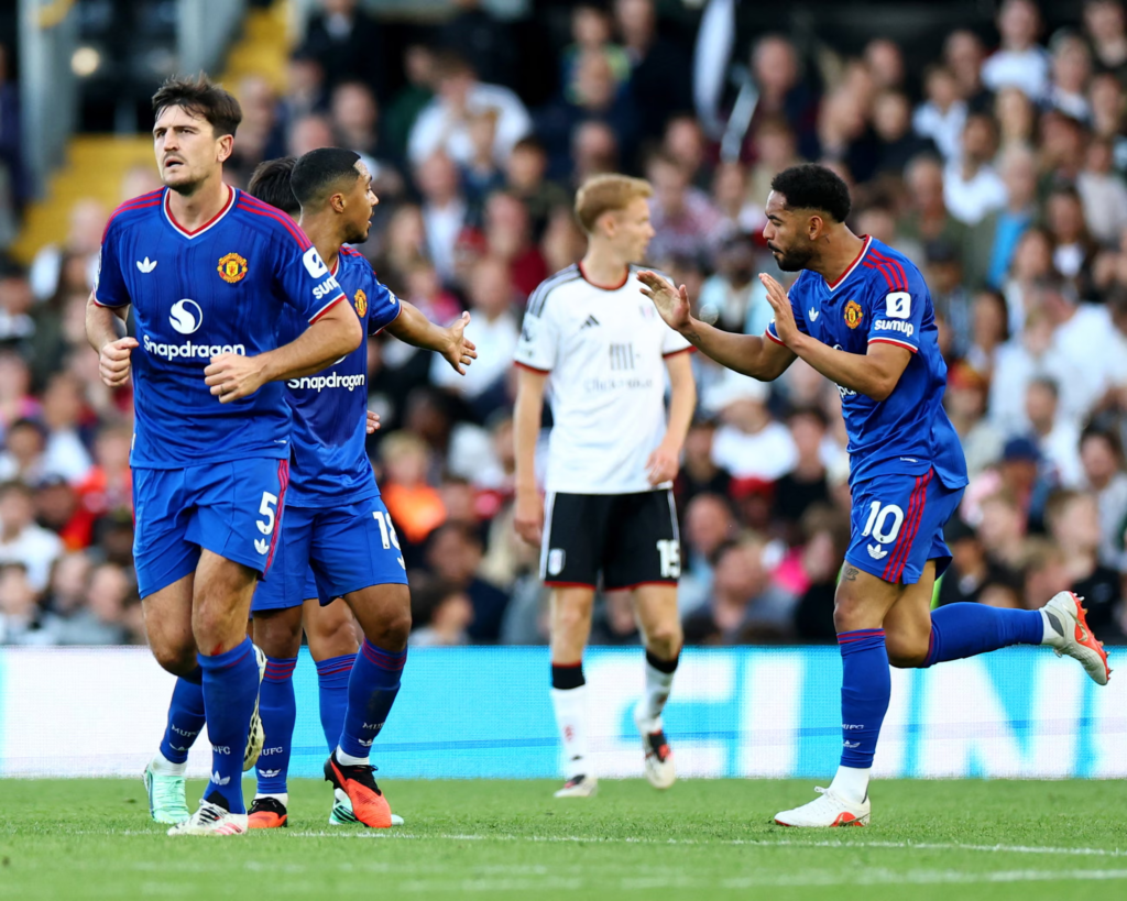 Manchester United player Matheus Cunha celebrating after scoring a deflected late equaliser.