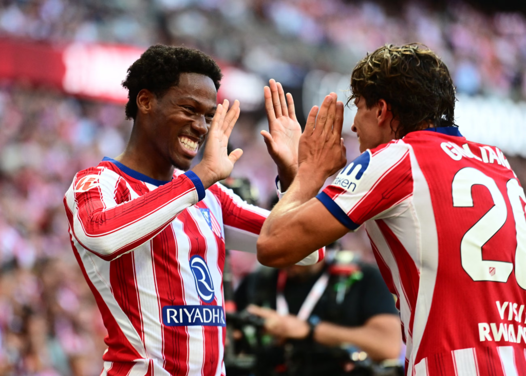 Atlético Madrid player Jonathan David high-fiving teammate Giuliano Simeone after scoring his side's second goal.