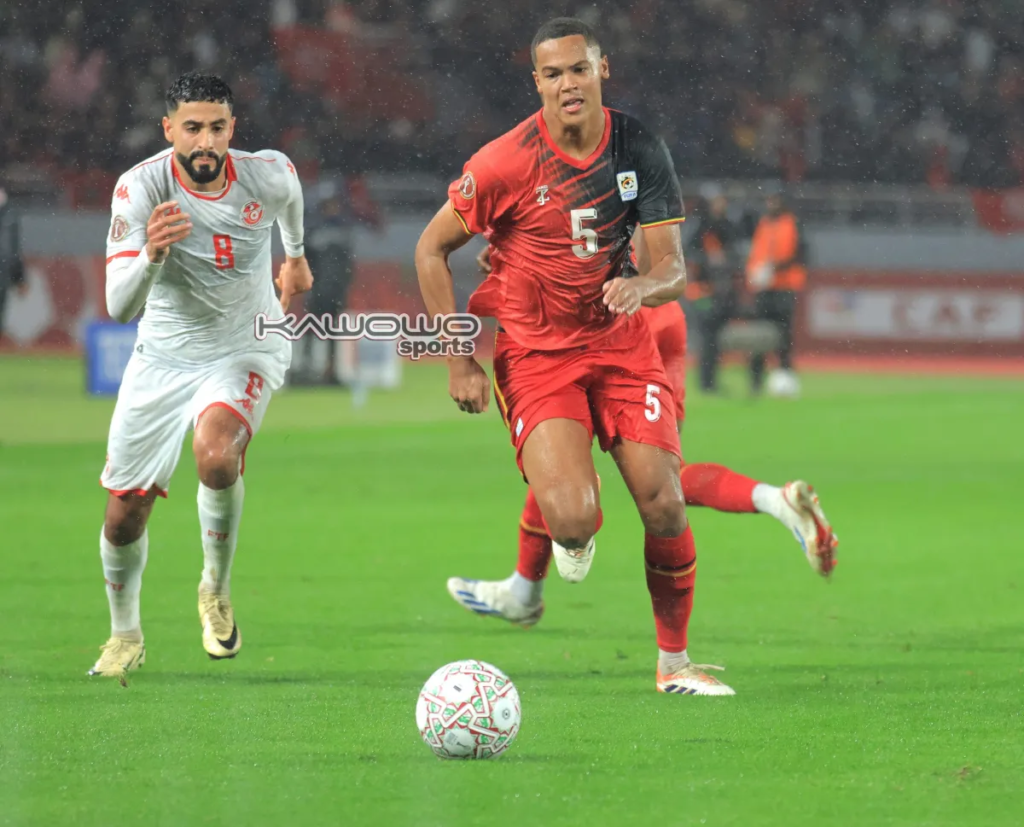Uganda Cranes' Toby Sibbick challenges Tunisia's Elias Said during the 2025 AFCON match at Stade Olympique de Rabat, Morocco.