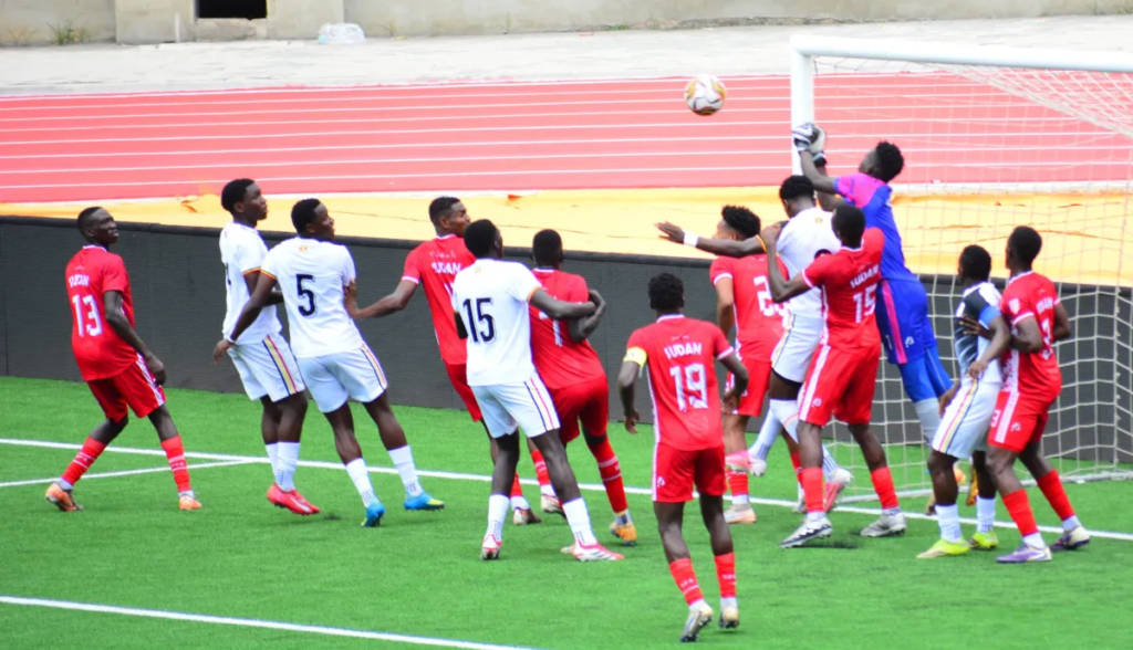 Players from Uganda U-20 and Sudan U-20 challenging for the ball during their match.