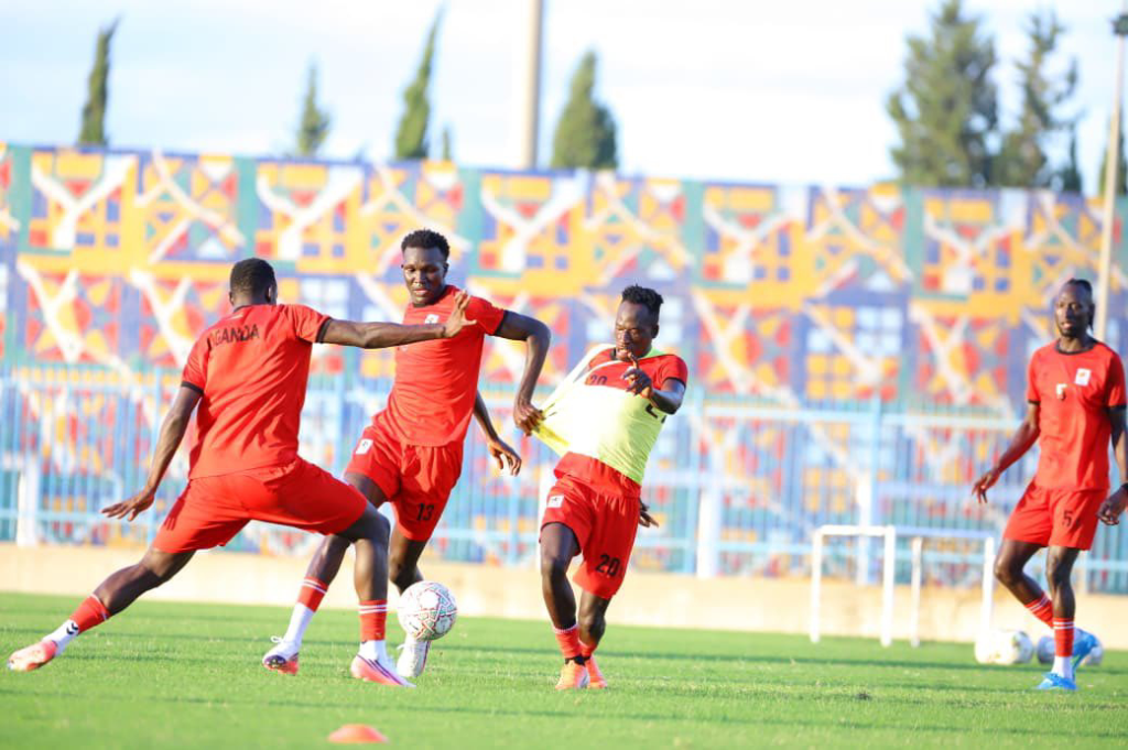 Uganda Cranes players in red training kits contesting for the ball during a training session ahead of their match against Tunisia.