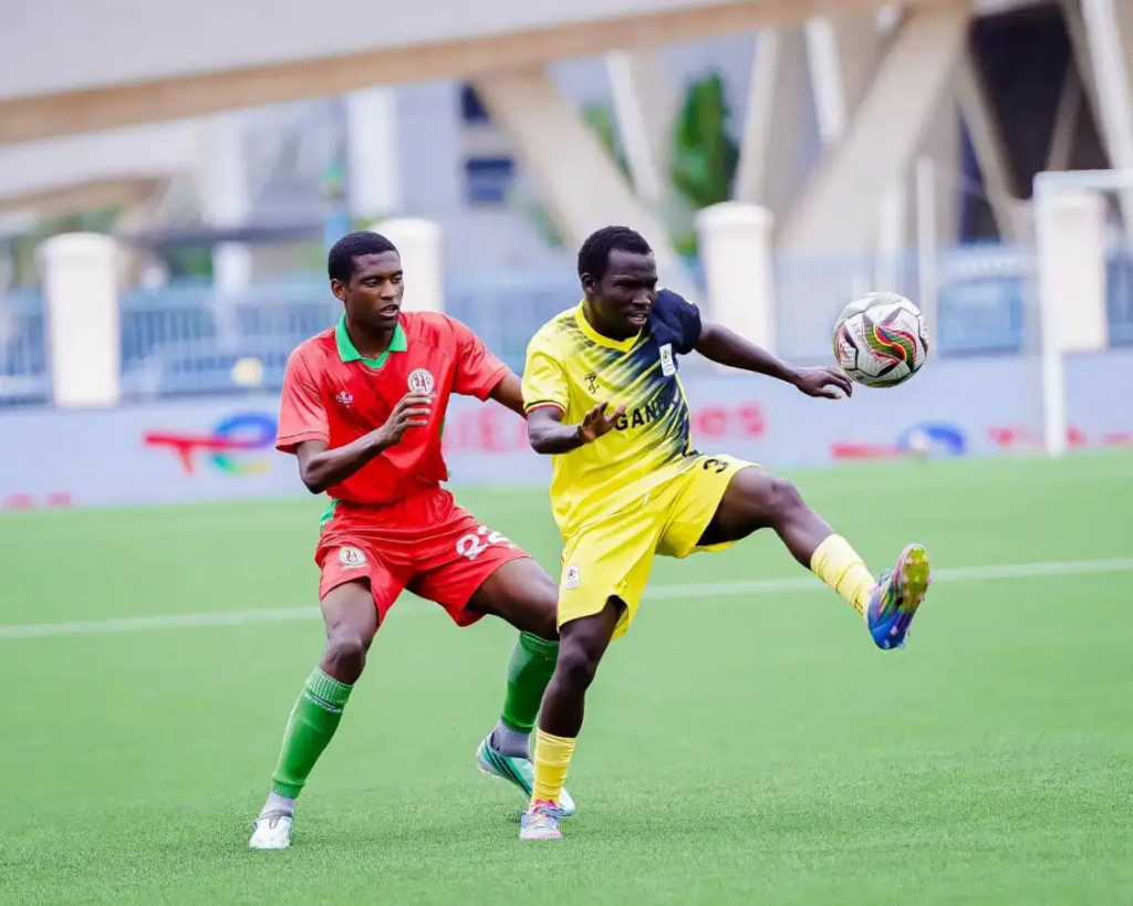 Uganda player Elvis Opakrwoth controlling the ball ahead of Ally Magambo.