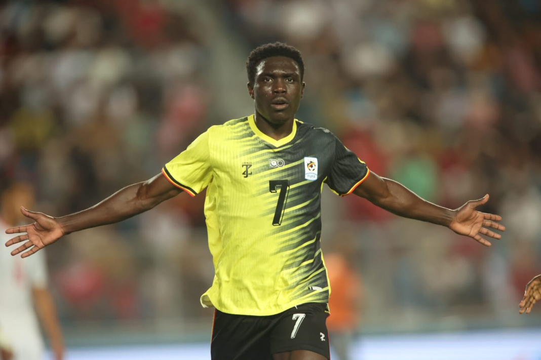 Uganda Cranes player Rogers Mato celebrating his equalising goal, securing the team's first recorded senior international point against Tunisia.