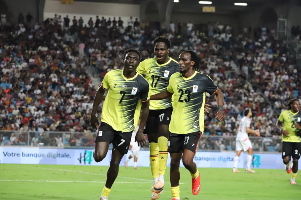 Uganda Cranes player Rogers Mato celebrating his goal with teammates Bogere and Aziz Kayondo. Credit: FUFA Media