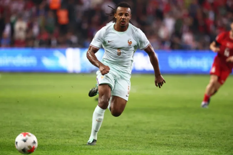 France defender Jules Koundé running with the ball during a match.
