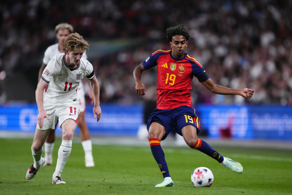 Barcelona's Lamine Yamal and England's Anthony Gordon competing for the ball during the UEFA Nations League match at Wembley Stadium, London.