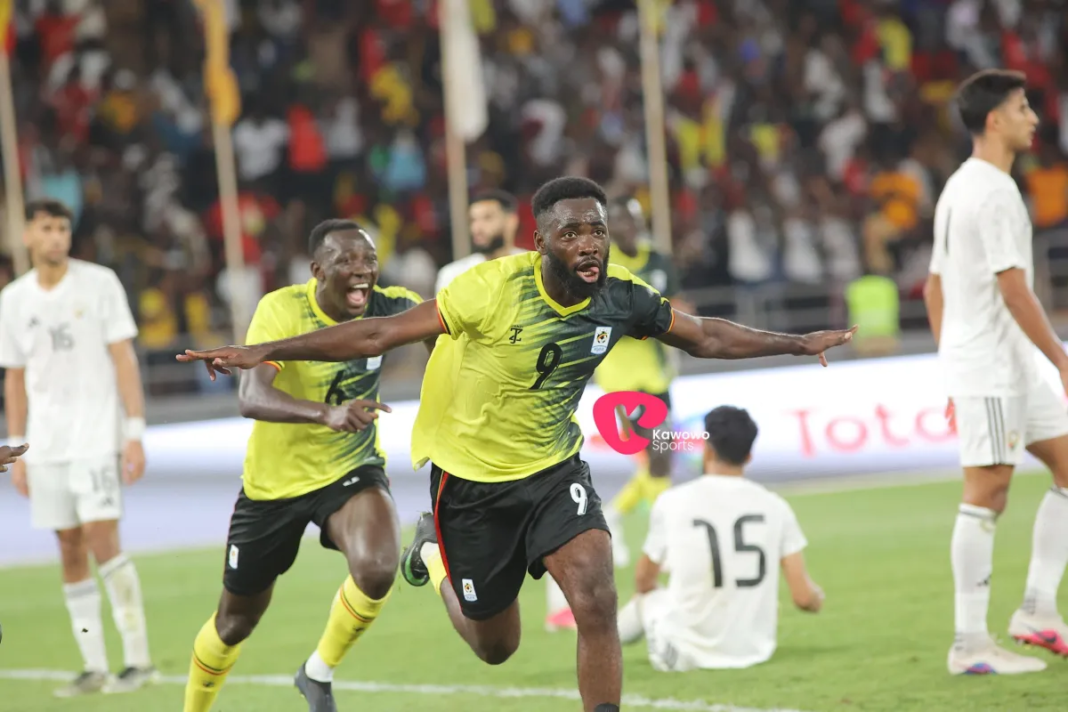Uganda Cranes player named Arnold Vula celebrating after scoring a goal.