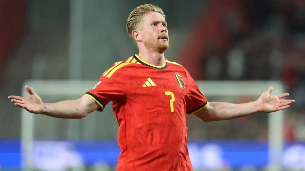 Belgium captain Kevin De Bruyne, arms outstretched, celebrating after scoring against Türkiye.