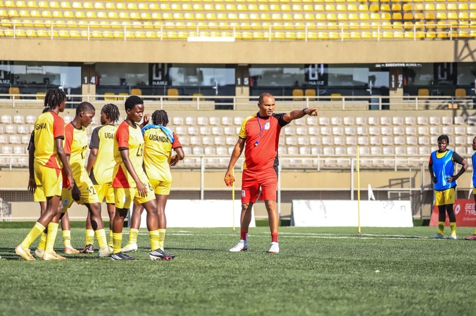 Uganda Crested Cranes players gathered for instructions from a coach during training at Hamz Stadium, Nakivubo, ahead of their match against Zambia.