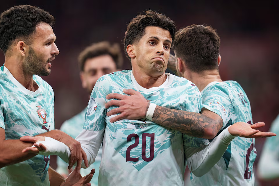 Portugal defender João Cancelo celebrating after scoring his team's first goal.