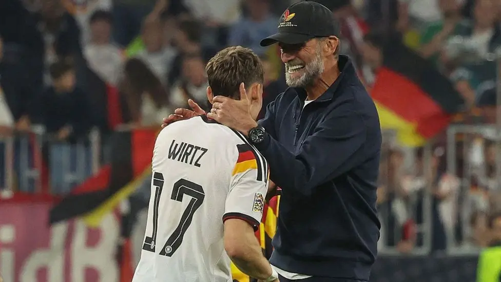 Germany player Florian Wirtz pictured on the left with head coach Jürgen Klopp on the right.