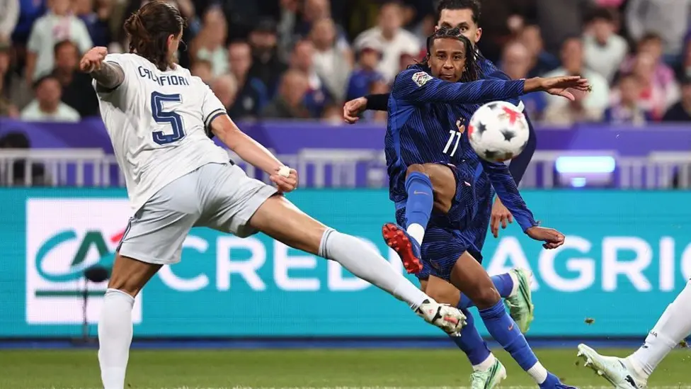 France's Michael Olise, wearing No. 11, striking the ball to score against Italy's Riccardo Calafiori.