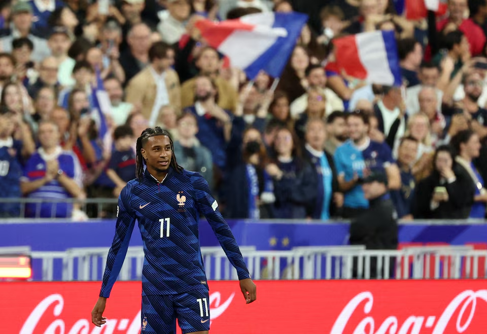 France forward Michael Olise celebrating after scoring his team's first goal.