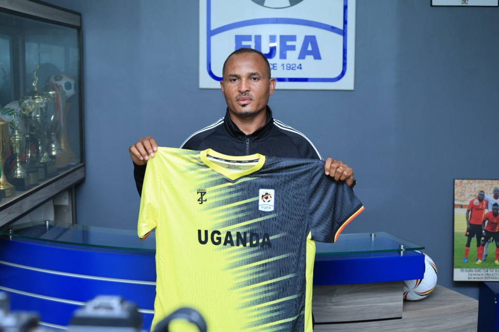 Firew Hailegebreal Asefa holds Uganda football jersey.