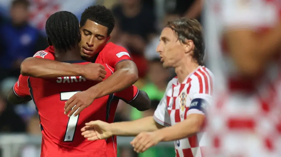 Croatia's Luka Modrić watching as England's Jude Bellingham congratulates Bukayo Saka after his goal in England's 7-0 win.