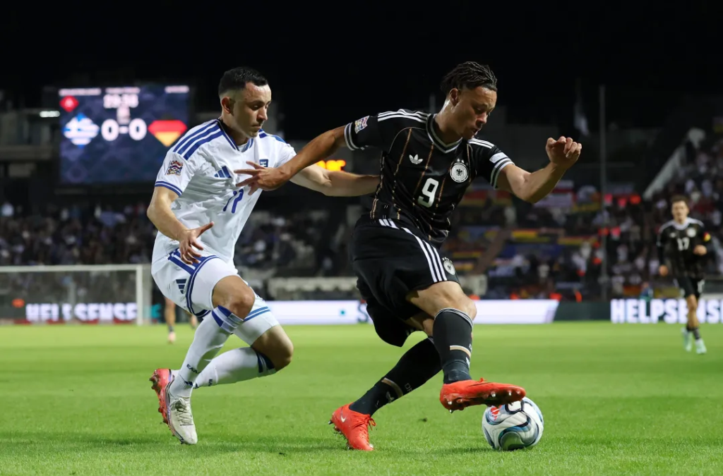 Germany's Derry Scherhant being challenged by Greece's Manolis Saliakas during the UEFA Nations League match at Toumba Stadium, Thessaloniki.