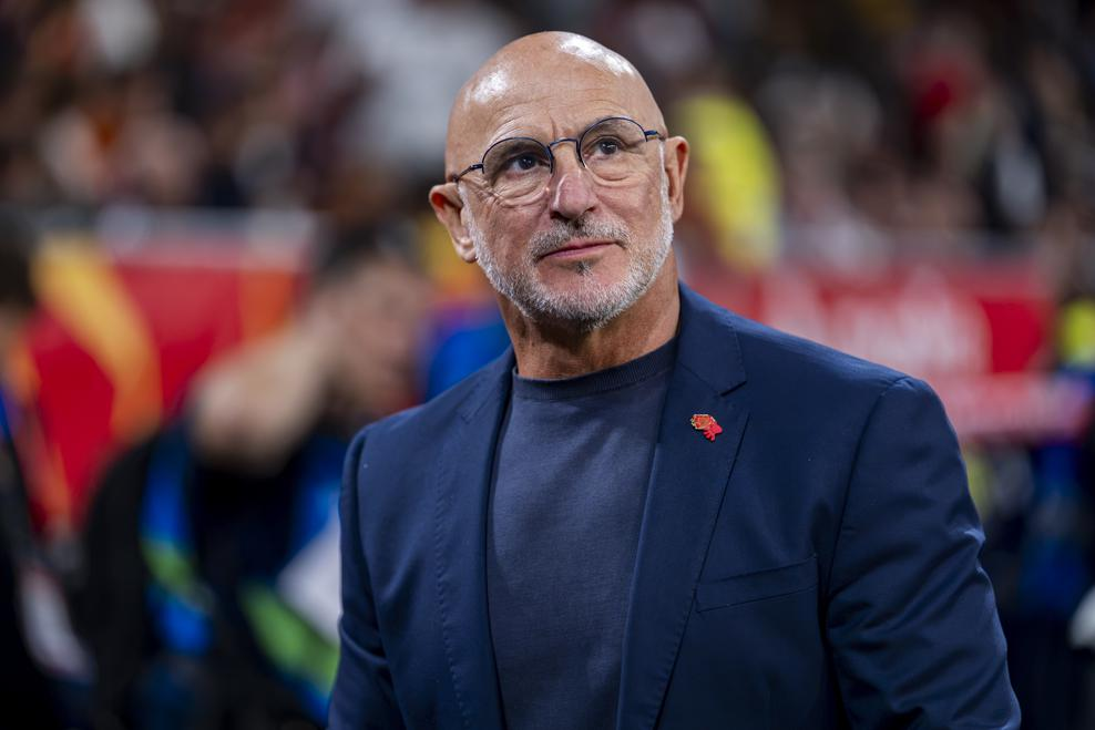 Spain head coach Luis de la Fuente, wearing glasses and a navy suit, pictured .