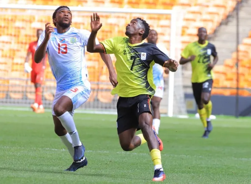 Uganda Cranes player Sadam Masereka challenging DR Congo's Brandon Ndezi, wearing No. 13, for the ball.