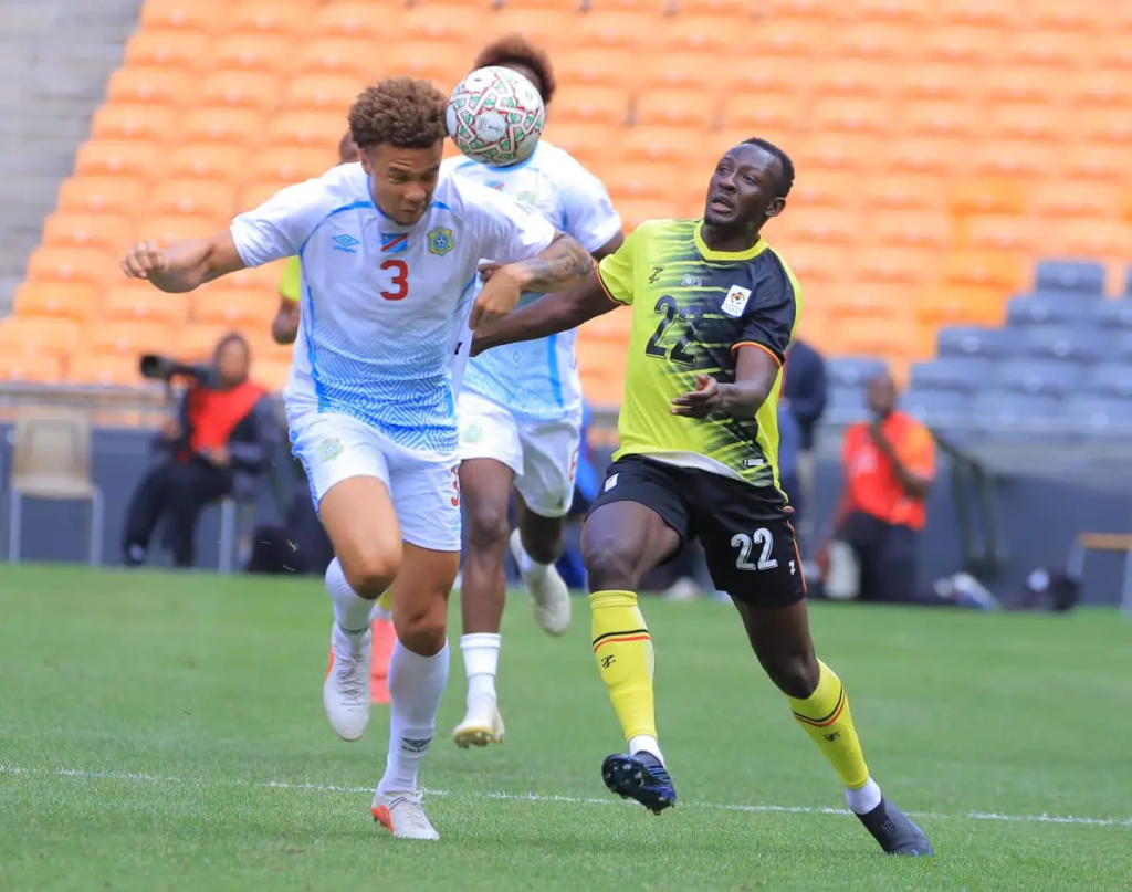 DR Congo's Steve Kapuadi and Uganda Cranes' Baba Alhassan battling for possession.