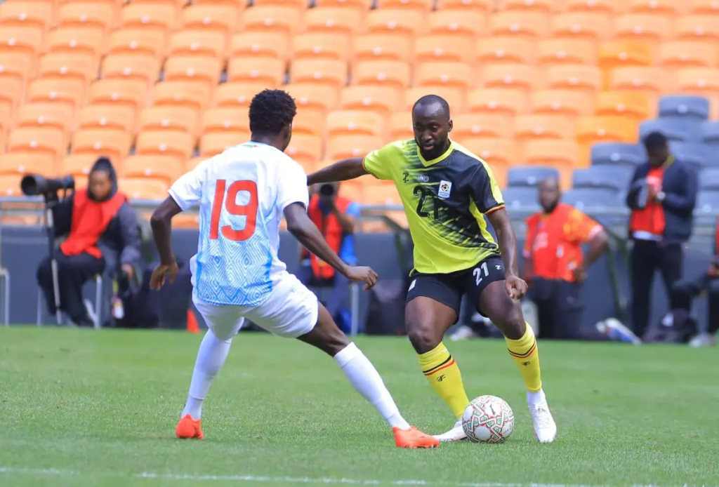 Uganda Cranes player Souleymane Diaby taking on DR Congo's Junior Kadile, wearing No. 19.