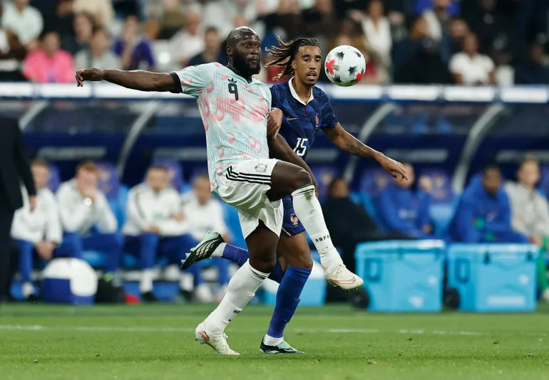 Belgium forward Romelu Lukaku challenging France's Leny Yoro for the ball.