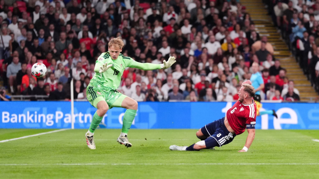 Czechia goalkeeper diving in vain as a header deflects off defender Vladimir Coufal to put England ahead.