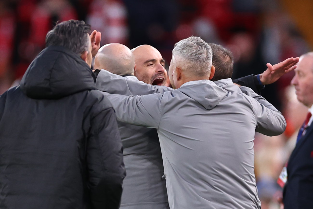 Enzo Maresca celebrating with members of his coaching staff after the final whistle.