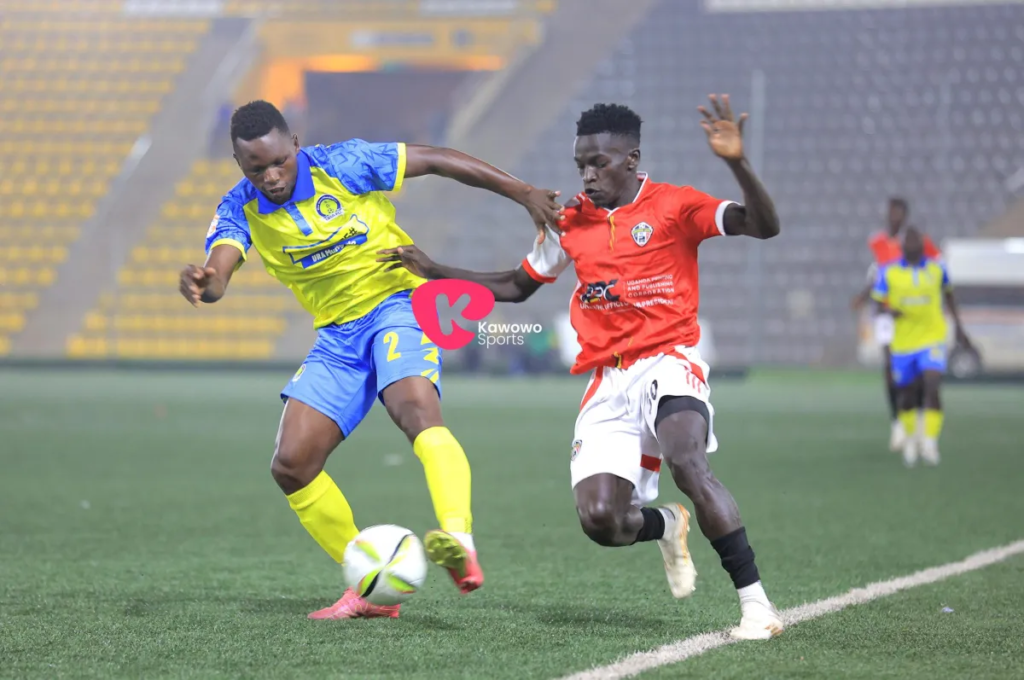 James Penz Begisa shielding the ball from Calvin Peter Emayu during a match.